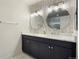 Elegant bathroom with a double vanity, marble tile, and modern lighting at 4520 Broadway St # 208, Boulder, CO 80304