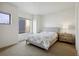 Bright bedroom with a queen-size bed, large window, and wooden dresser at 4520 Broadway St # 208, Boulder, CO 80304
