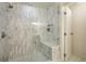 Spacious shower with marble tile, glass enclosure, and built-in bench at 4520 Broadway St # 208, Boulder, CO 80304