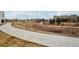 Concrete walkway winds through green space towards homes at 4520 Broadway St # 208, Boulder, CO 80304