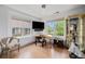 Home office with hardwood floors, natural light, built-ins and minimalist decor at 7611 S Addison Way, Aurora, CO 80016