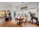 Dining room with wood floors, natural light, decorative giraffe statue, and seating for four at 7611 S Addison Way, Aurora, CO 80016