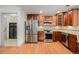 Modern kitchen features stainless steel appliances and stylish wood cabinetry at 7611 S Addison Way, Aurora, CO 80016