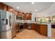 Bright, updated kitchen with stainless appliances, dark wood cabinets, and breakfast bar at 7611 S Addison Way, Aurora, CO 80016