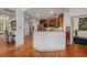 Open kitchen with stainless steel appliances, wood floors and ample counter space at 7611 S Addison Way, Aurora, CO 80016