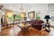 Elegant living room features hardwood floors, a decorative chandelier, and large windows with a great view at 7611 S Addison Way, Aurora, CO 80016