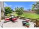 Back patio with an outdoor dining set and lush landscaping creates a perfect outdoor living space at 7611 S Addison Way, Aurora, CO 80016