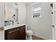 Well-lit half bathroom with a modern vanity and a window at 9628 Dunning Cir, Highlands Ranch, CO 80126