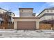 A well-maintained two-car garage with a neutral exterior, and a large brown garage door at 9628 Dunning Cir, Highlands Ranch, CO 80126