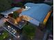 Aerial view of home and xeriscaped yard at dusk with carport and lighting at 2545 S Lowell Blvd, Denver, CO 80219