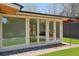 Exterior view of house featuring bedroom windows, backyard access, and lush landscaping at 2545 S Lowell Blvd, Denver, CO 80219