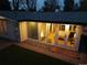 Exterior view of house featuring bedroom windows, backyard access, and lush landscaping at 2545 S Lowell Blvd, Denver, CO 80219