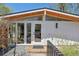 Home's front entrance featuring stylish wood and glass door with accent lighting at 2545 S Lowell Blvd, Denver, CO 80219