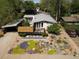 Charming home with xeriscaped yard featuring colorful succulents and modern fence at 2545 S Lowell Blvd, Denver, CO 80219