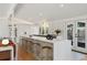 Modern kitchen with white cabinets, gold stools, and open floor plan at 2545 S Lowell Blvd, Denver, CO 80219
