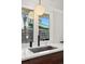 Close-up of the kitchen sink with a black faucet, a stainless steel sink, and a view of the backyard at 2545 S Lowell Blvd, Denver, CO 80219