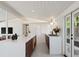 Contemporary kitchen with white countertops, wood cabinets, and modern appliances and lots of natural light at 2545 S Lowell Blvd, Denver, CO 80219