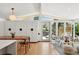 Bright living room with hardwood floors, minimalist decor, large windows, and doors to the outside deck at 2545 S Lowell Blvd, Denver, CO 80219