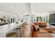 Open-concept living room with an island, a kitchen with modern finishes, and a comfortable seating area at 2545 S Lowell Blvd, Denver, CO 80219