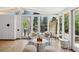 Bright living area with modern furnishings, hardwood floors, and large windows at 2545 S Lowell Blvd, Denver, CO 80219
