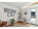 Bright office featuring a desk, shelving, hardwood floors and backyard access at 2545 S Lowell Blvd, Denver, CO 80219