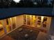 The stylish patio is lit up at night and features a rock garden and exterior lighting at 2545 S Lowell Blvd, Denver, CO 80219