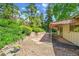 A serene back patio with lovely stonework, gravel bed, and a covered area perfect for grilling at 11267 W Colorado Pl, Denver, CO 80232