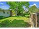 Lush backyard features a large shade tree and ample space for outdoor activities and landscaping at 11267 W Colorado Pl, Denver, CO 80232