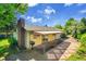 Charming backyard with a covered patio area, grill, and access to the house through sliding glass doors at 11267 W Colorado Pl, Denver, CO 80232