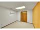 Basement room featuring wood-paneled accent wall and a closet with sliding doors at 11267 W Colorado Pl, Denver, CO 80232