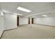 Spacious basement featuring neutral carpet and white painted walls with doors at 11267 W Colorado Pl, Denver, CO 80232