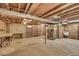 Unfinished basement with concrete floor, utility sink and exposed ceiling beams at 11267 W Colorado Pl, Denver, CO 80232