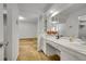 Spacious bathroom featuring a vanity with a sink, open to the bedroom at 11267 W Colorado Pl, Denver, CO 80232