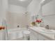 Clean, well-maintained bathroom featuring a tub/shower combination and neutral decor at 11267 W Colorado Pl, Denver, CO 80232