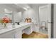 Well-lit bathroom featuring a large vanity with sink, toilet, and neutral flooring at 11267 W Colorado Pl, Denver, CO 80232