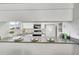 Kitchen with white cabinetry, modern appliances, and a functional breakfast bar at 11267 W Colorado Pl, Denver, CO 80232