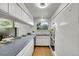 Bright kitchen with white cabinetry, stainless steel appliances, and hardwood floors at 11267 W Colorado Pl, Denver, CO 80232