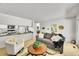 Cozy living room featuring comfortable seating, an open layout, and a view of the kitchen at 11267 W Colorado Pl, Denver, CO 80232