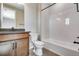 This bathroom has a tiled shower, dark cabinets, a toilet, and a dark countertop at 3422 N Gold Bug Ct, Aurora, CO 80019