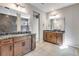 This bathroom features dual vanities with granite counters, wood cabinets, and a large glass shower with tiled herringbone pattern at 3422 N Gold Bug Ct, Aurora, CO 80019