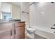 This bathroom has a tiled shower, dark cabinets, a toilet, and a dark countertop at 3422 N Gold Bug Ct, Aurora, CO 80019
