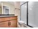 Modern bathroom features a glass-enclosed shower, sleek vanity with dark countertop, and stylish fixtures at 3422 N Gold Bug Ct, Aurora, CO 80019