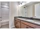 This bathroom has a tiled shower, dark cabinets, a toilet, and a dark countertop at 3422 N Gold Bug Ct, Aurora, CO 80019