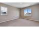 This spacious bedroom features neutral carpet, fresh paint, and bright windows with neighborhood views at 3422 N Gold Bug Ct, Aurora, CO 80019