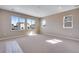 This spacious bedroom features neutral carpet, fresh paint, and bright windows with neighborhood views at 3422 N Gold Bug Ct, Aurora, CO 80019