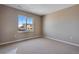 This spacious bedroom features neutral carpet, fresh paint, and bright windows with neighborhood views at 3422 N Gold Bug Ct, Aurora, CO 80019