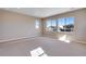 This spacious bedroom features neutral carpet, fresh paint, and bright windows with neighborhood views at 3422 N Gold Bug Ct, Aurora, CO 80019