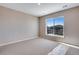 This spacious bedroom features neutral carpet, fresh paint, and bright windows with neighborhood views at 3422 N Gold Bug Ct, Aurora, CO 80019