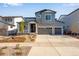 Charming two-story home with stone accents, a two-car garage, and well-maintained landscaping, creating a welcoming curb appeal at 3422 N Gold Bug Ct, Aurora, CO 80019