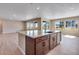 Open-concept kitchen: large island offers seamless access to dining and living areas, enhancing entertainment at 3422 N Gold Bug Ct, Aurora, CO 80019
